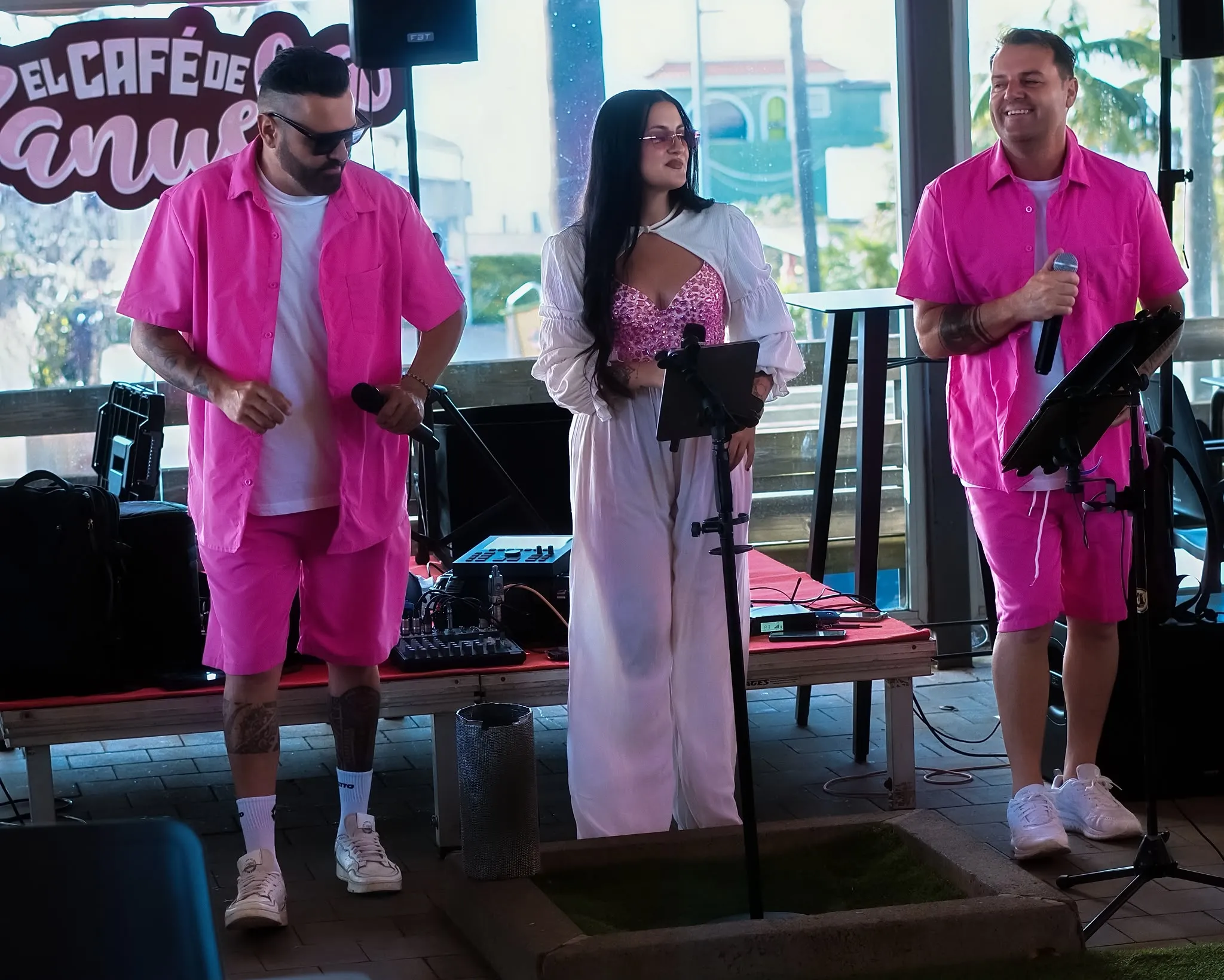 Grupo La Calle performing on the terrace at El Café de Manuela, with the café sign behind them