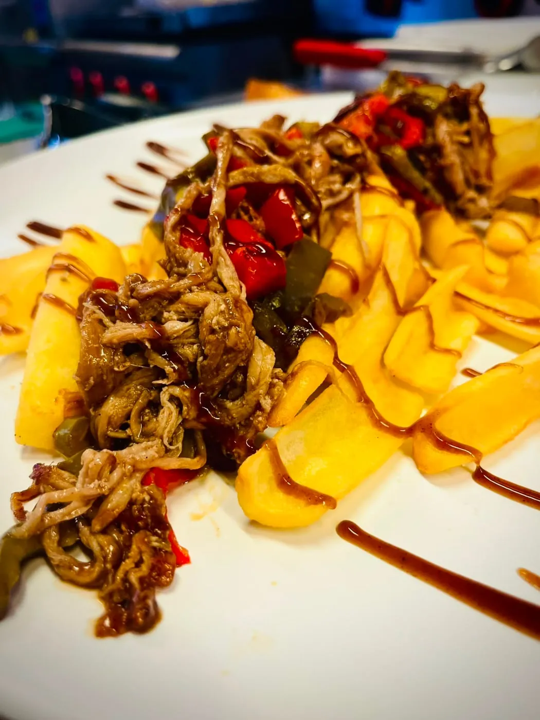 Loaded chips with pulled pork, peppers and sauce