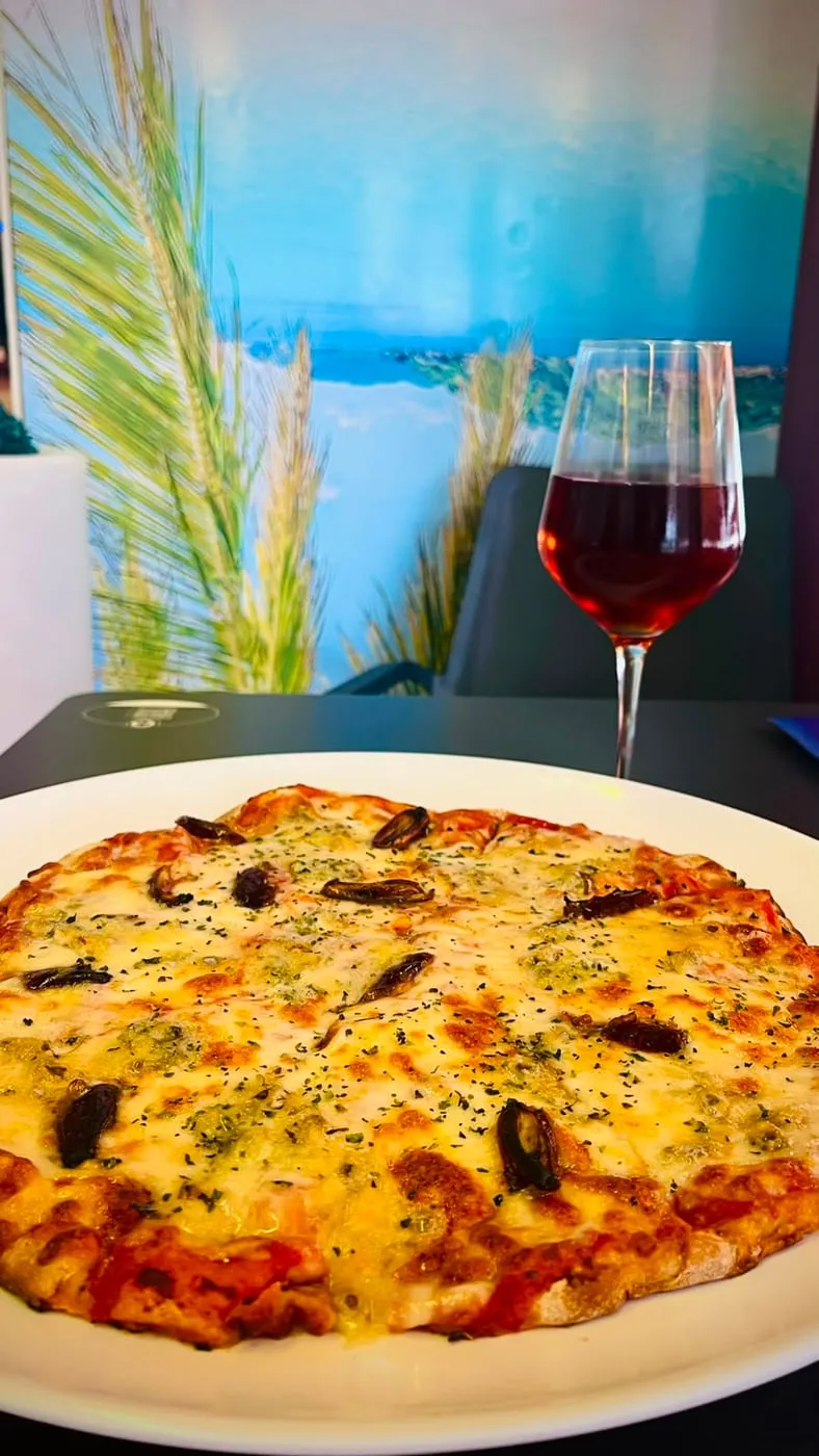 Freshly made pizza with a thin base and golden crust