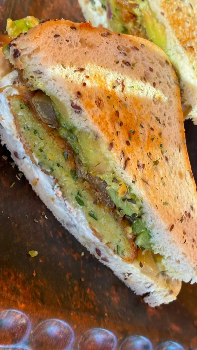 Vegetarian sandwich on seeded bread, with avocado and caramelised onion