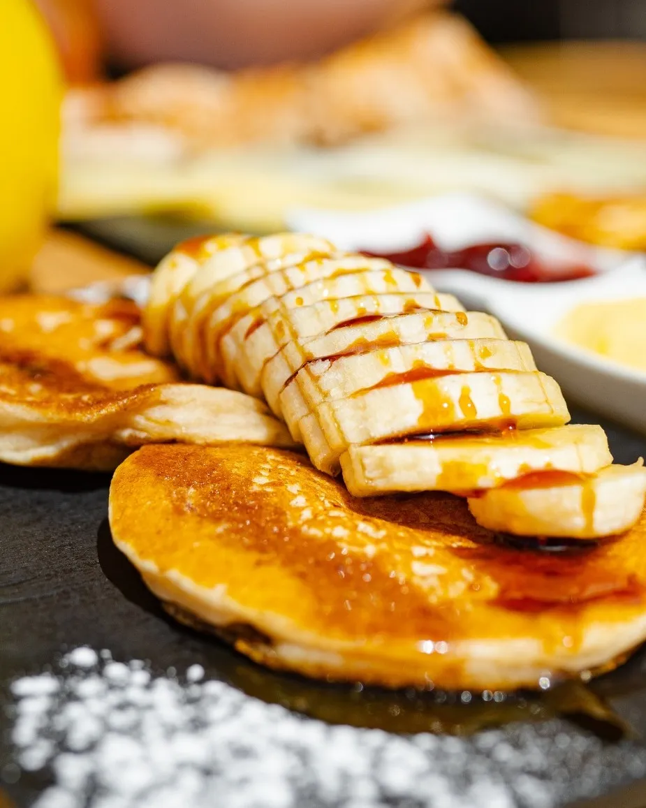 Homemade pancakes with fruit and palm honey