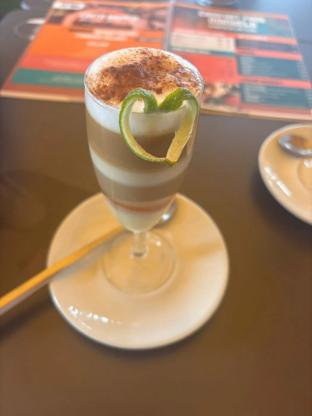 Zaperoco on the table, dusted with cinnamon and topped with a heart of lime peel